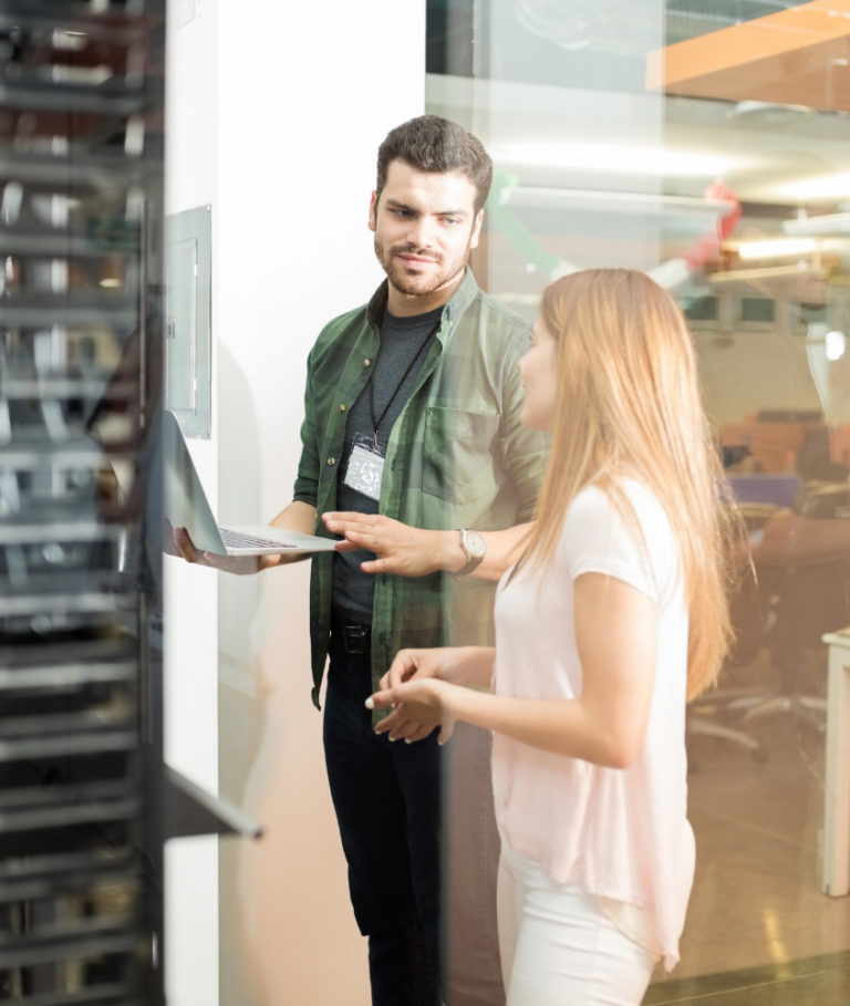 Colleagues standing in a data center and chatting